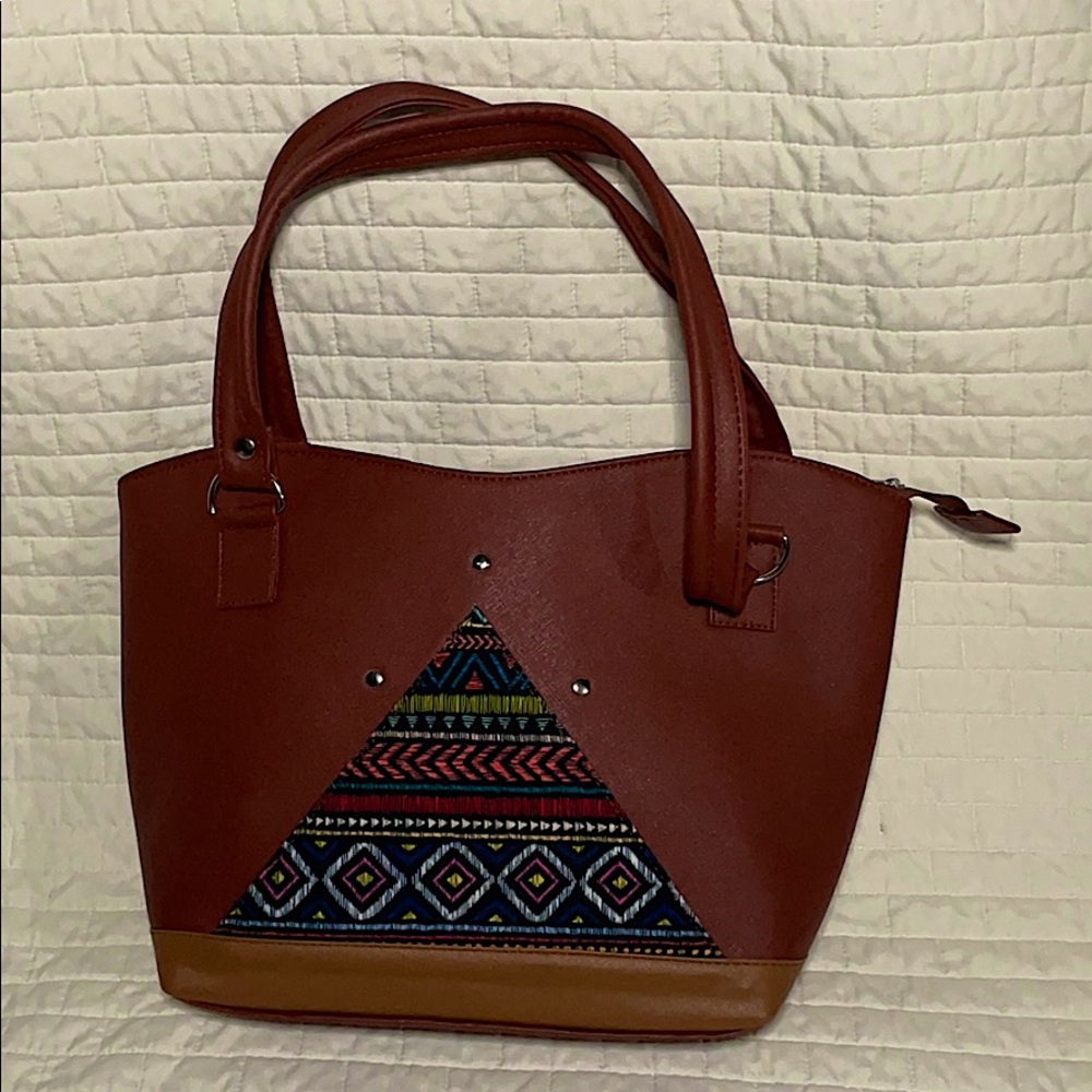 Brown tote bag with many designs printed on front